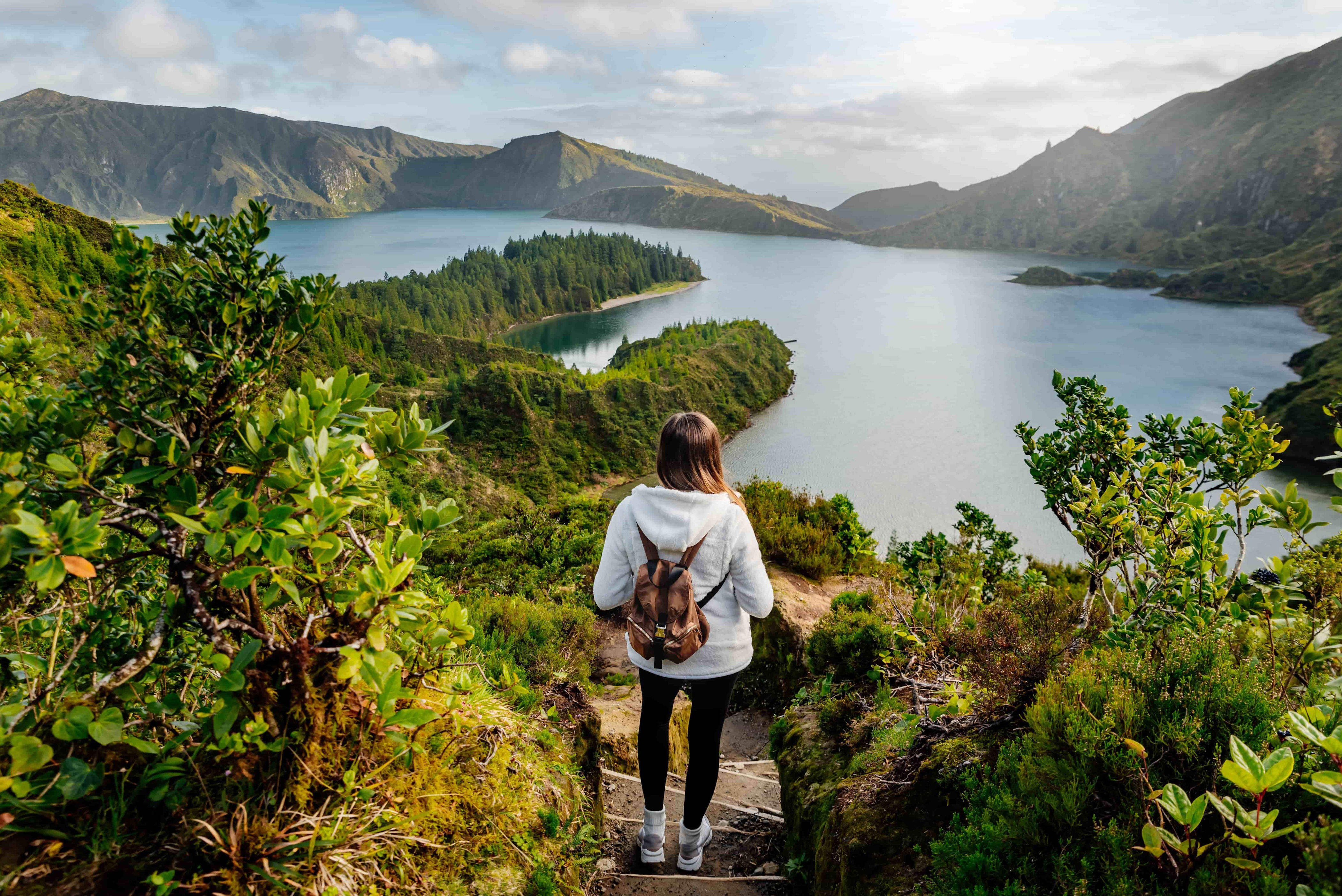 The biggest island in the Azores archipelago, São Miguel is nicknamed “The Green Island” (it’s also been called the “<a href="https://www.travelandleisureasia.com/global/destinations/europe/sao-miguel-island-is-called-the-hawaii-of-europe/#:~:text=Destinations-,This%20Island%20Is%20Called%20The%20'Hawaii%20Of%20Europe'%20%E2%80%94%20With,Volcanic%20Peaks%20And%20Beautiful%20Waterfalls&text=The%20largest%20island%20in%20the,its%20most%20pure%2C%20pristine%20stage." rel="noreferrer noopener">Hawaii of Europe</a>”) because of its lush and dramatic landscape featuring black sand beaches. The volcanic crater lake Lagoa do Fogo, at the centre of the island, is considered a must-see because of its beautiful vistas and hiking opportunities. <a href="https://www.visitazores.com/en/experience-the-azores/whale-watching" rel="noreferrer noopener">Whale watching</a> is also a popular activity to book, as the Azores is one of the world’s largest whale sanctuaries, with more than 20 different cetacean species swimming in the waters.