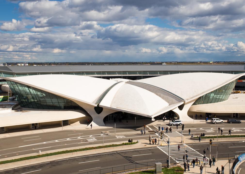 <p>In 2019, Eero Saarinen's landmark TWA Flight Center—originally a terminal for the defunct Trans World Airlines—was reborn as a hotel, the only one inside John F. Kennedy International Airport in New York City.</p>  <p>Built in 1962, Saarinen was commissioned to design not just a terminal but a grand structure representing and advertising the airline, an assignment he flourished. The terminal embodied modernity, featuring an elevated footbridge, large windows, and red velvet lounge chairs. Red carpet whisked travelers to and from the terminal.</p>  <p>From the outside, its aerodynamic design (a key component of Googie architecture) features a four-part thin-shell concrete rooftop composed of slanting and angled segments that, together, resemble a bird or a supersonic jet in flight.</p>