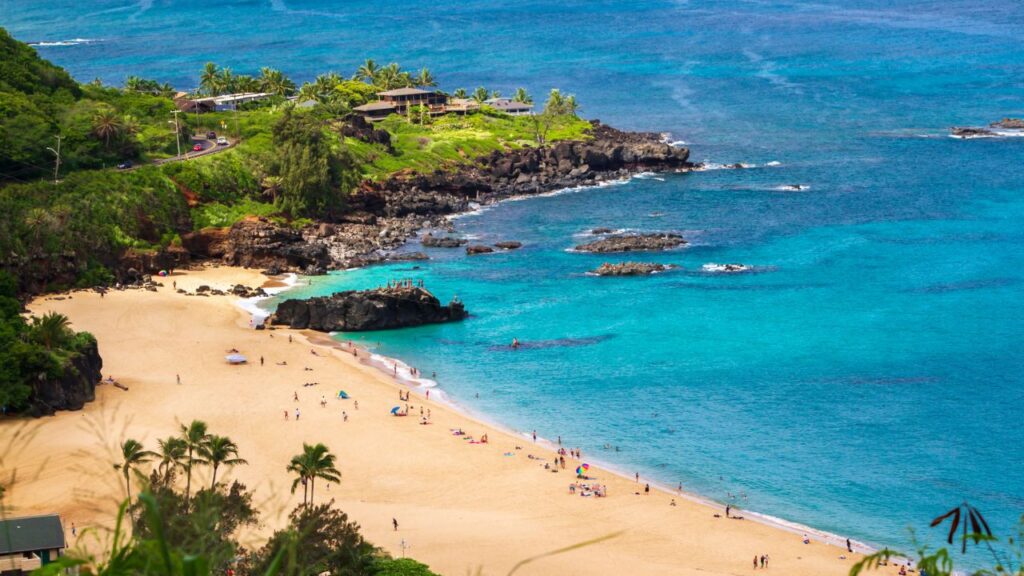 <p>On Oahu's North Shore, Waimea Bay is known for its giant winter waves and professional surfing contests. During the summer, the bay becomes calm and is excellent for swimming and diving. The beach also features a large rock that people enjoy jumping into the water. Waimea Bay is adjacent to Waimea Valley and is known for its historical and cultural significance.</p>