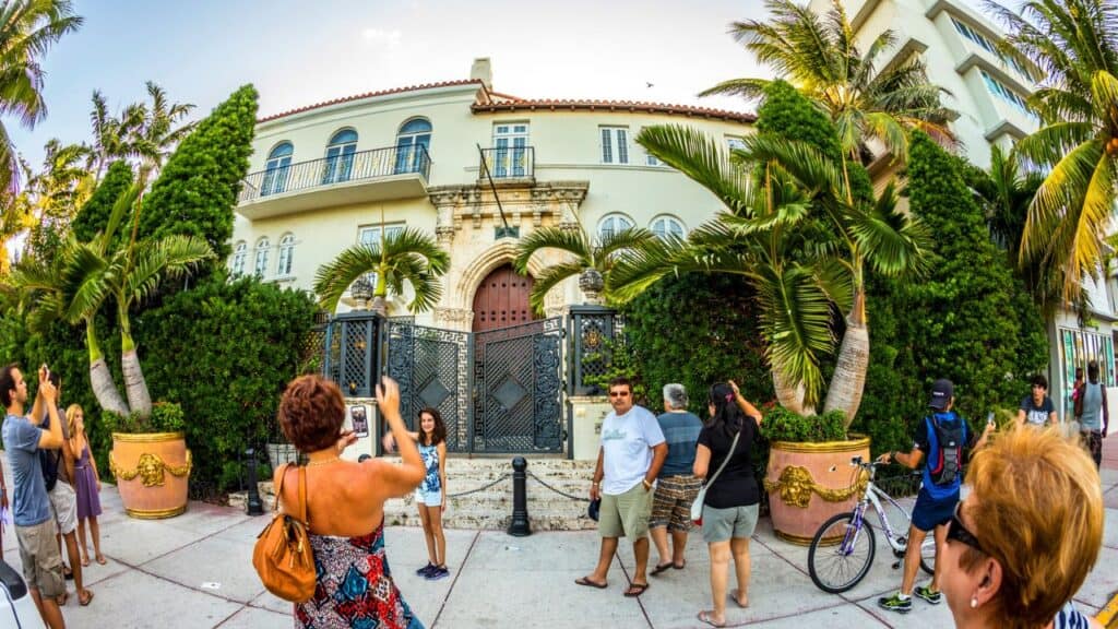 <p><em>Recommended by Ashley of JetsetJansen.com</em></p><p>Tucked away in one of the busiest streets of Miami is the famed <a href="https://jetsetjansen.com/versace-mansion-miami/" rel="noopener">Versace Mansion</a>. If you don’t know it’s there, you might easily walk by it or mistake it for any boutique hotel–which it is. The famous building, once owned by fashion designer Gianni Versace, sits in the middle of Ocean Drive on Miami Beach. Versace spent millions on the renovations, which include the thousands of imported Italian tiles that make up the iconic pool. </p><p>The entrance to the Versace Mansion happens to be the location of Gianni’s murder, which was portrayed in American Crime Story. After his death, the house was bought and turned into a boutique hotel, now known as the Villa Casa Casuarina. The hotel group purchased much of the original furniture at auction and maintained the interiors closely to the Versace style. Many of the walls are hand-painted, and the hotel has lots of intricate tile work. </p><p>To get a glimpse of the world of Versace, you’ll need to book a stay at the hotel or make a reservation for lunch or dinner. While a reservation at the restaurant doesn’t allow you to tour the house, you do get to see the outdoor courtyard and the famous pool. </p>