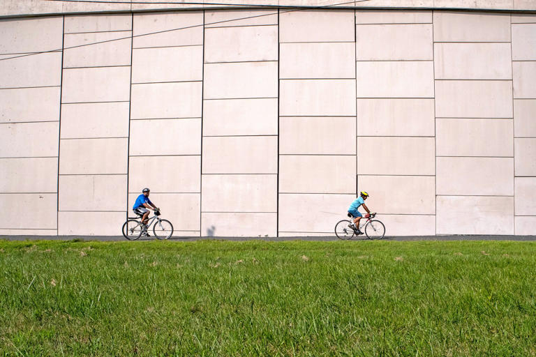 Visitors bike along the Jack A. Markell Trail (the "JAM") parallel to the Delaware Turnpike in New Castle, Thursday, Aug. 17, 2023. The JAM, which runs 5.5. miles, connects to, through off-road elevated boardwalk, paved pathways, the Wilmington Riverwalk to New Castle, and includes an one on-road section through Historic New Castle, totaling 7.9 miles.