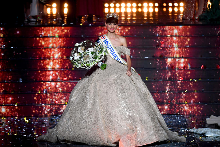Newly elected Miss France 2024, Miss Nord-Pas-de-Calais Eve Gilles reacts on stage after winning the title during the Miss France 2024 (AFP via Getty Images)