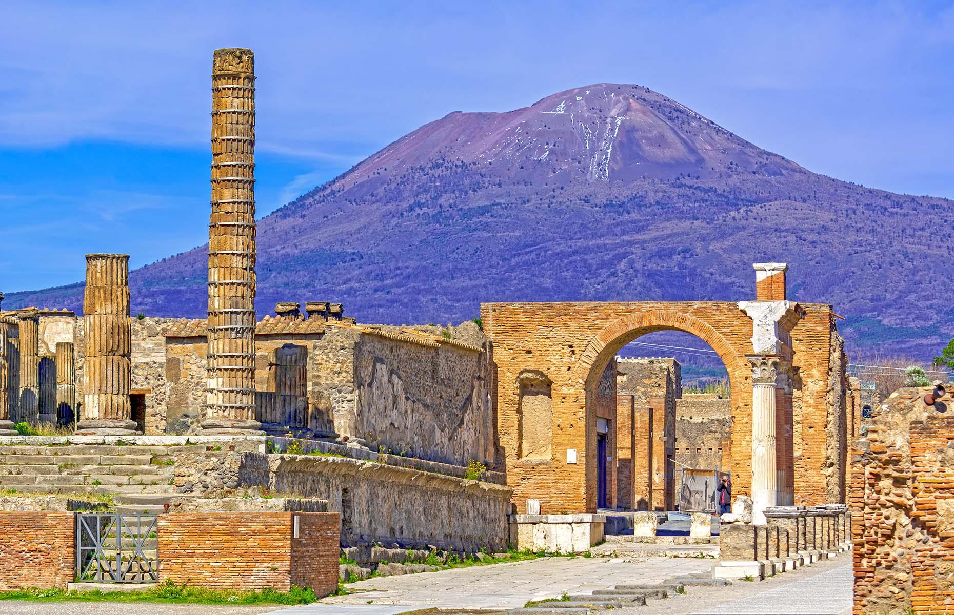 <p>As people were sitting down to lunch, a light dusting of ash began to drift over Pompeii, followed by heavier downfalls of white pumice stone and debris raining over the town, driven south from the spewing cone of Mount Vesuvius. Some townspeople managed to flee – clinging to as many treasures, jewellery or coins as they could carry with them – while others sought shelter in basements as the roofs of houses began to collapse under the weight of the rocks.</p>