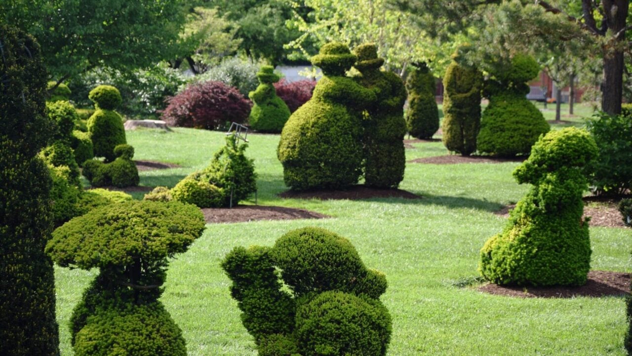 <p>If you’re familiar with painter George Surat, his masterpiece Sunday Afternoon on the Island of La Grande Jatte will undoubtedly bring a beautiful water scene to mind. As for Topiary Park in Downtown <a href="https://www.sandandorsnow.com/things-to-do-in-columbus-ohio/" rel="noopener">Columbus</a>, creator James T. Mason gets the accolade for the seven-acre recreation. In 1989, when he and his wife pitched the concept to the Ohio capitol city, James created everything from the bronze frames that make up the topiaries’ interiors but carved out the pond and created hills. With 54 people, three dogs, a cat, a monkey, and eight boats, yew trees were used for each piece. </p>