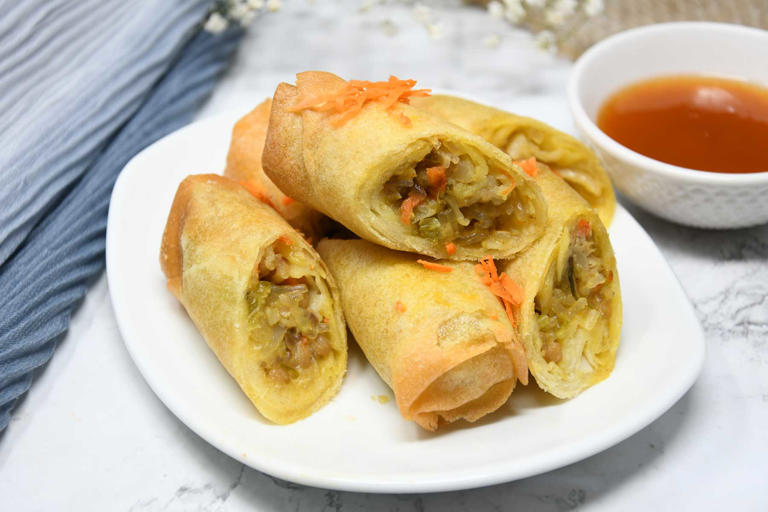 Air fryer frozen spring rolls served with sweet sauce.