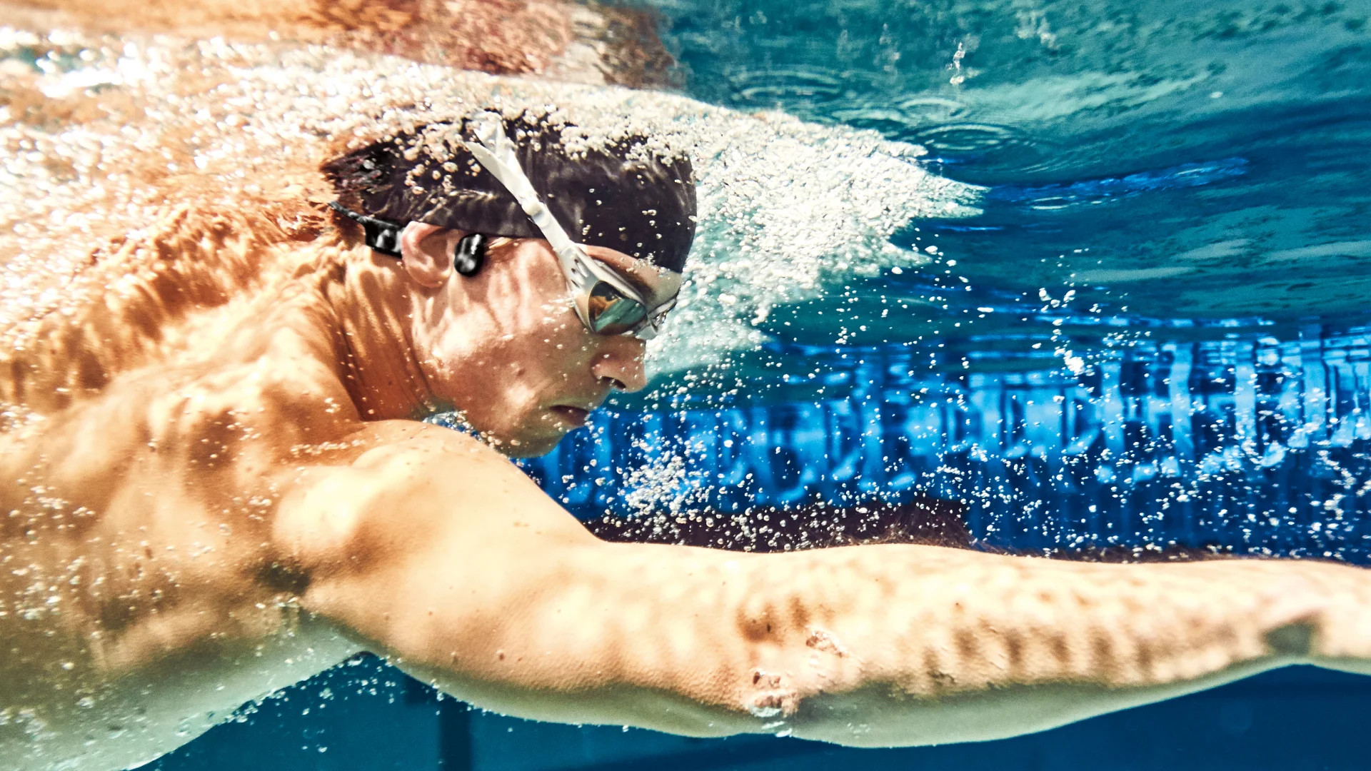 Shokz openswim. Наушники для плавания в бассейне AFTERSHOKZ. Shokz openswim фотографии упаковки.