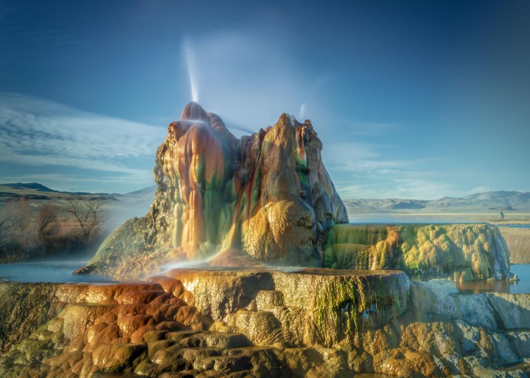 <p>The Fly Geyser was accidentally created in 1964 as a result of an artesian well, but the results are still spectacular. Because different mineral deposits—such as algae, iron, and sulfur—coexist, the water from the geyser spews five feet in the air in numerous vibrant colors. Although Fly Geyser is located on private property, visitors can still <a href="https://blackrockdesert.org/flygeysernaturewalk/">book tours</a> to see it on the weekends.</p>