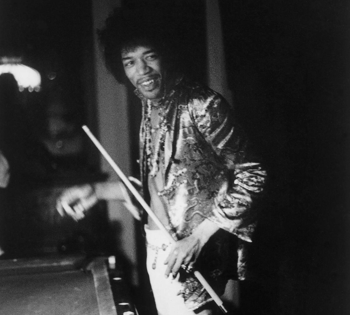 <p>Jimi Hendrix is one of the most celebrated guitarists of the 20th century. </p> <p>Just because he is a high-profile star doesn't mean Hendrix didn't like his downtime. Here, we see the guitarist smiling while playing a game of pool at a friend's house back in 1967. </p>