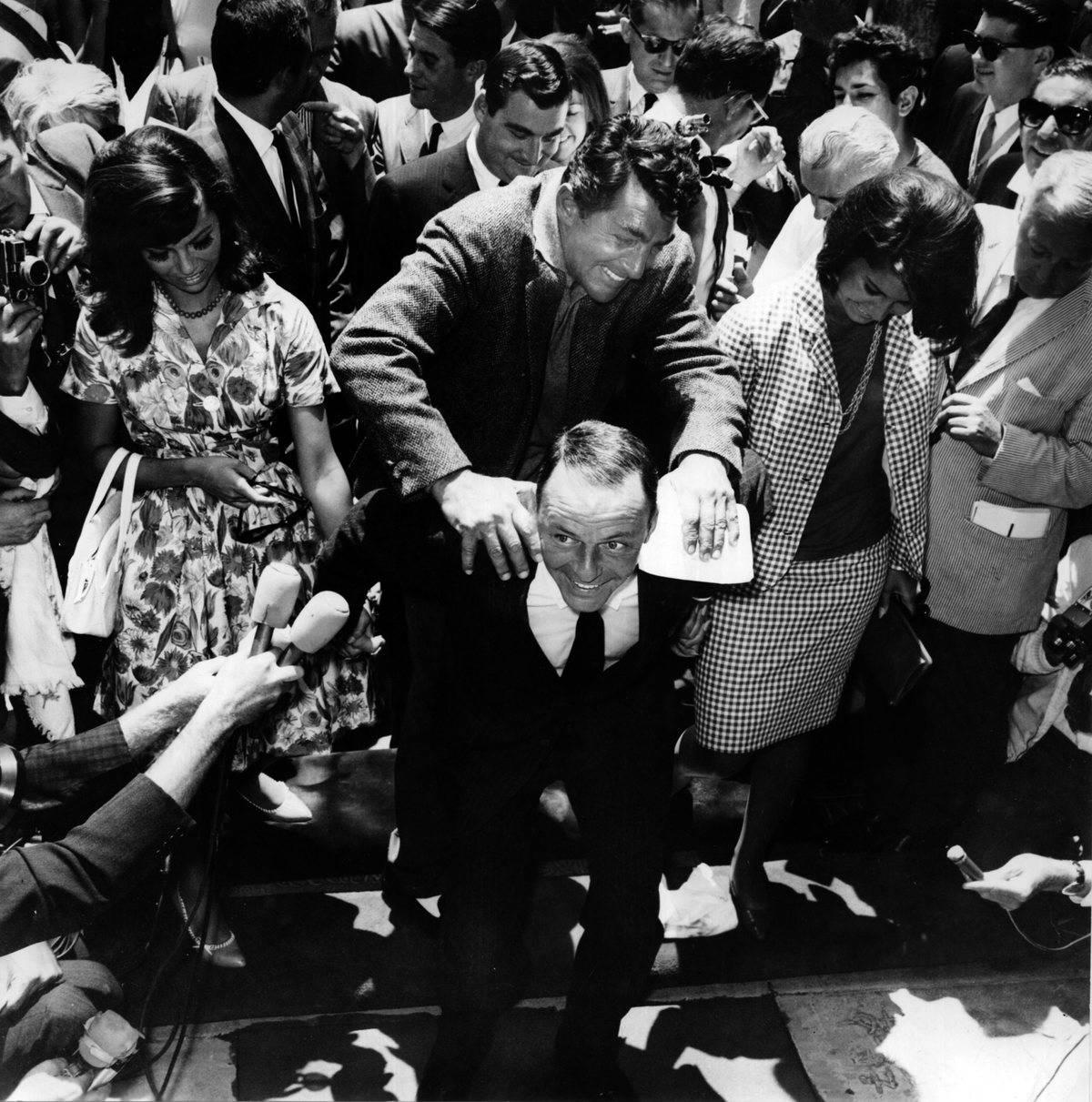 <p>On July 20, 1965, the grounds surrounding Grauman's Chinese Theatre in Hollywood, California, were packed for a handprint ceremony for singer Frank Sinatra. </p> <p>As you can tell from the picture, fellow singer, Dean Martin, was very happy for his long-time friend.</p>