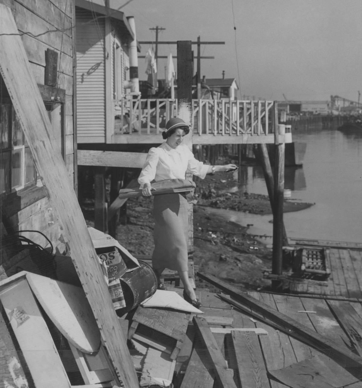 <p>Before the United States Census was mailed to each American household, or the internet was up and running, people would walk door-to-door, counting heads to determine the population in each state. </p> <p>In this case, United States Census taker Marjorie Kelso of Oakland, California, was captured via photograph walking among the docks of the ark community of houseboats off Alameda Avenue. Tucked into her side is a large book, where she will tally the heads living in each household.</p>
