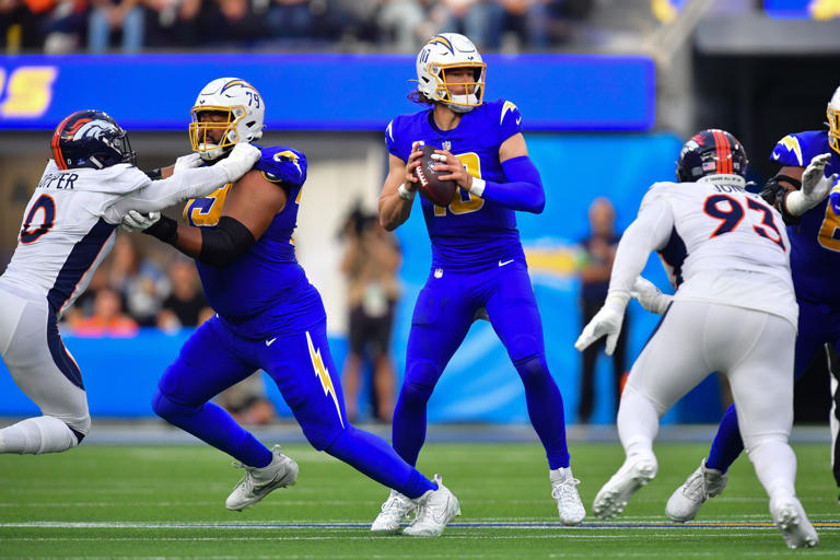 Los Angeles Chargers quarterback Justin Herbert (10) drops back to pass against the Denver Broncos during the first half at SoFi Stadium.