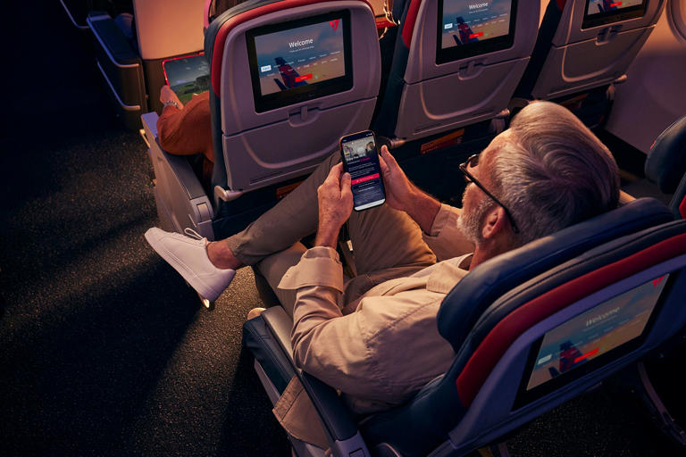 Man sits in DELTA COMFORT+ Seat_DELTA AIR LINES