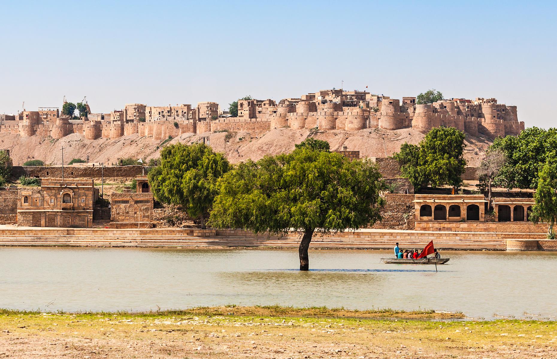 <p>Watch the sunrise over the sand dunes at the honey-hued fort city which rises magnificently out of the Thar Desert. The color of the sandstone architecture has earned Jaisalmer the tag of the Golden City. It's known for its grand havelis – former mansions of the city's wealthy merchants, embellished with exquisite carvings.</p>