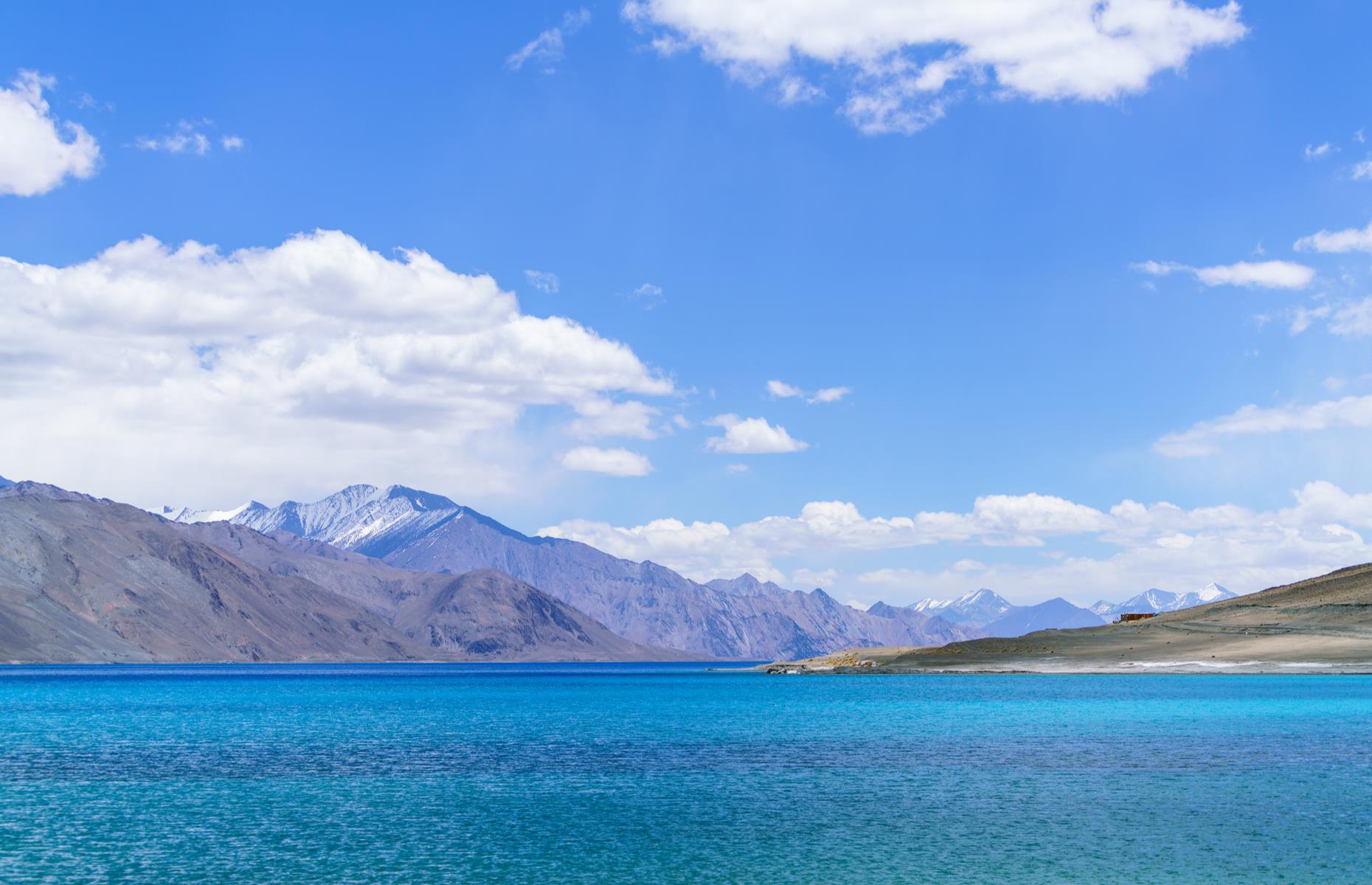 <p>Ladakh’s high-altitude lake is renowned for its startlingly blue waters that seem to shift color throughout the day. This long and narrow stretch of water extends into western Tibet – stroll along the southern shore to appreciate the sight of the snow-capped Pangong Range reflected in the water.</p>