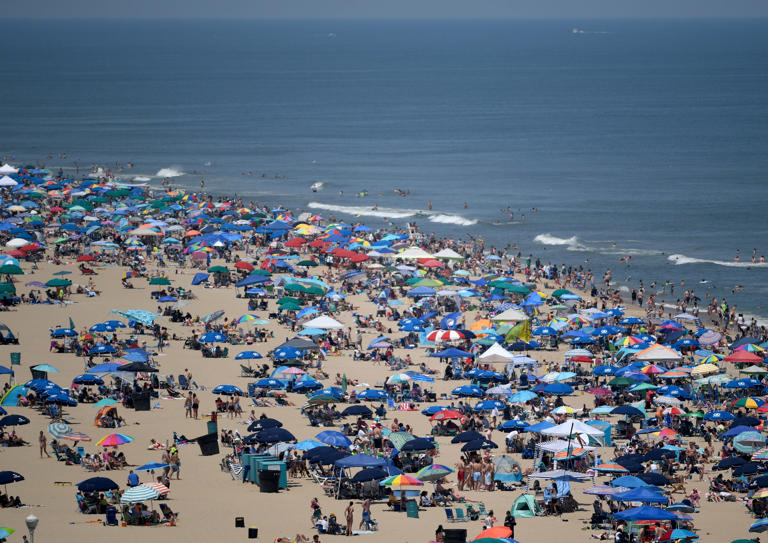 People crowd on the beach to watch the OC Air Show Saturday, June 10, 2023, in Ocean City, Maryland.