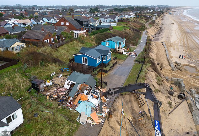 'rip' is spray painted onto the front of norfolk clifftop home torn down by demolition teams just weeks before christmas after suffering from coastal erosion