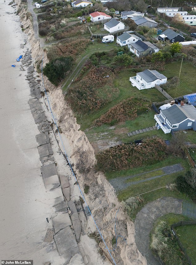 'rip' is spray painted onto the front of norfolk clifftop home torn down by demolition teams just weeks before christmas after suffering from coastal erosion