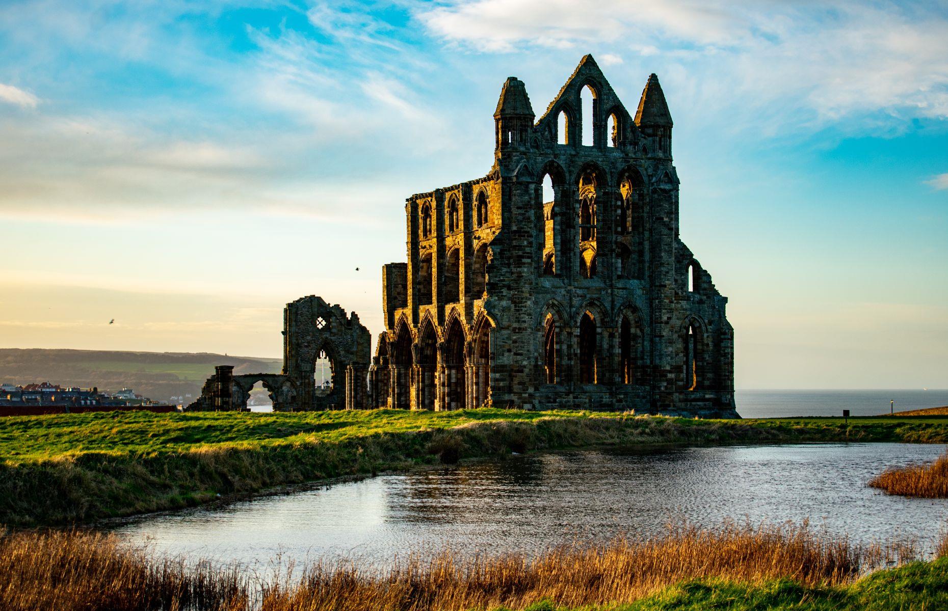 <p>Perched on a cliff overlooking the North Sea, the imposing façade of <a href="https://www.english-heritage.org.uk/visit/places/whitby-abbey/">Whitby Abbey</a> is one of the most celebrated sights in North Yorkshire. The construction of the first Gothic church began around 1225 but, due to lack of funds, it was only finished a few centuries later. The abbey was forced to close in the mid-16th century following the dissolution of monasteries and was stripped away. Bad weather, along with bombardment during the Second World War, has eroded much of the abbey’s remains, giving it a hauntingly beautiful and suitably Gothic appearance.</p>