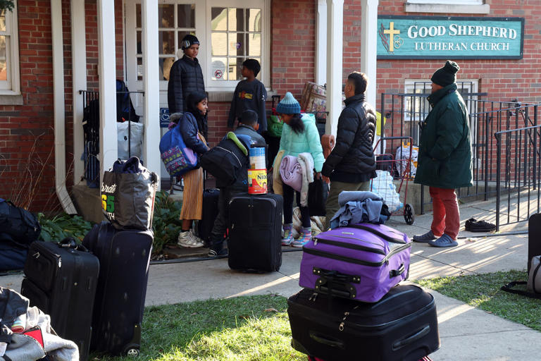 Migrants and their belongings are seen outside Good Shepherd Lutheran Church in Oak Park, Illinois, on Nov. 1, 2023, where they were being given shelter.
