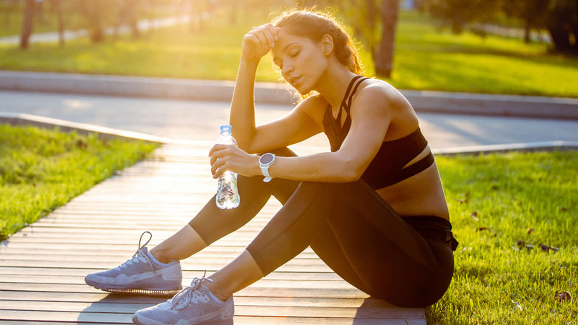 woman drinking water after a workout