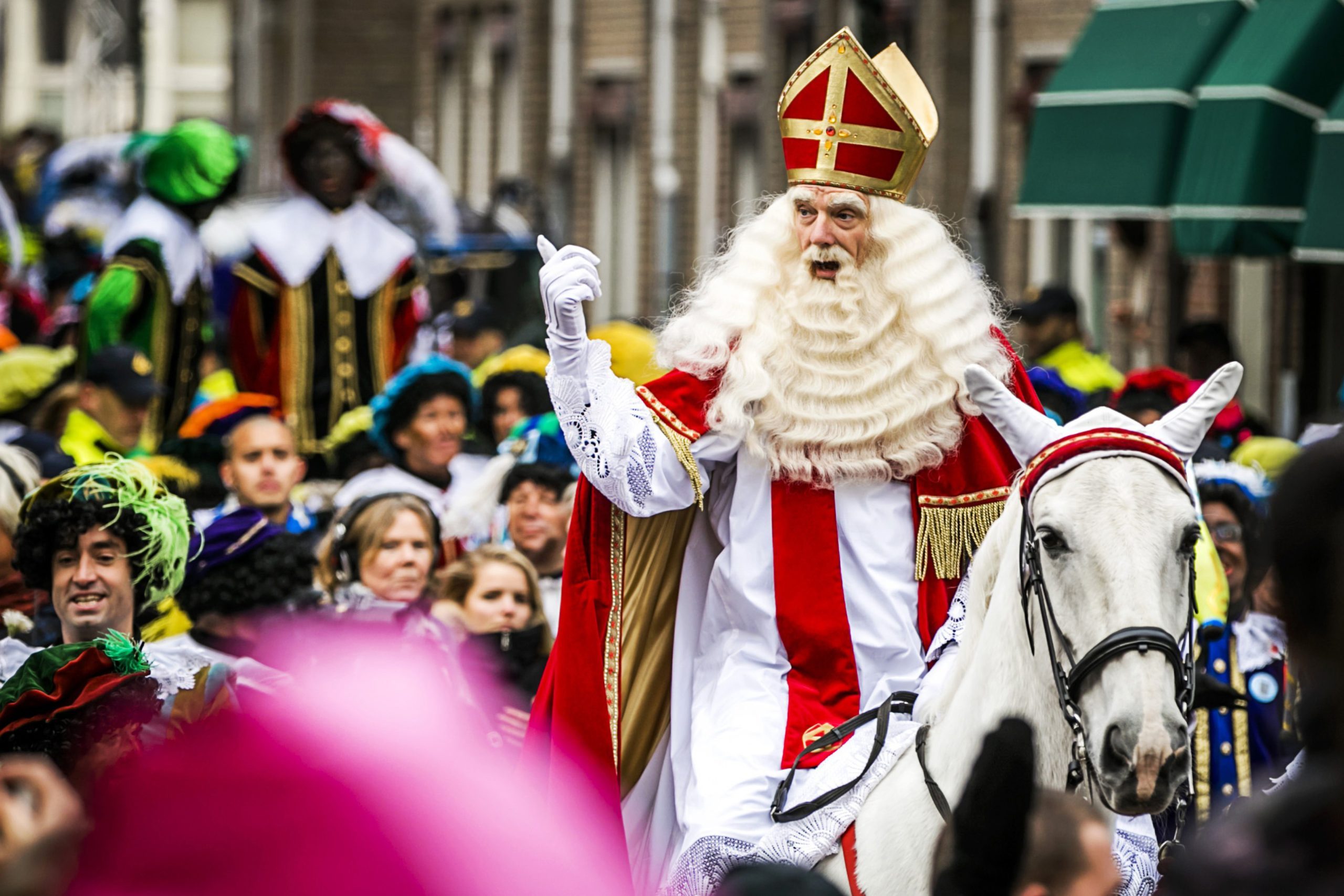 <p>Sinterklaas is still celebrated in the Netherlands on St. Nicholas's feast day, Dec. 6. He shares some similarities with Santa, such as his white beard, but he's dressed as a bishop in traditional Catholic red robes (this is also why Santa Claus wears red, one of the traditional <a href="https://www.rd.com/article/christmas-colors-green-red/" rel="noopener noreferrer">Christmas colors</a>). Sinterklaas rides a white horse, a holdover from the Norse god Odin, who flew on a horse during the winter solstice celebration of Yule. Since St. Nicholas's feast day was near the solstice, it was also combined with elements of solstice holidays, Brown says.</p>