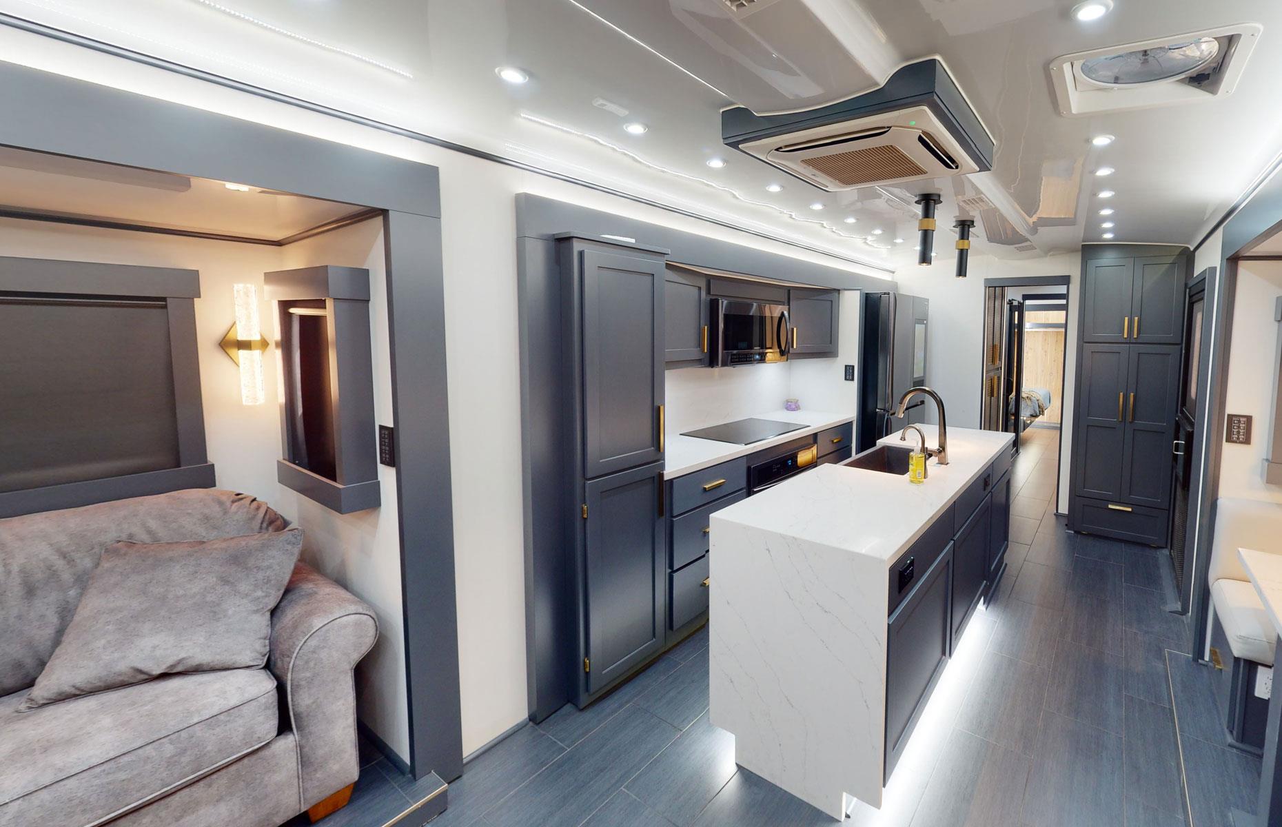 <p>As you can see from this photo of a typical custom trailer from the company, the décor is simple and elegant, with a smart, traditional feel.</p>  <p>Space is cleverly used and quality fixtures and fittings add to the high-spec finish. The living area flows well and is a cut above the sort of interior you'd expect to find in an RV. </p>  <p>In this particular model, the sleek kitchen features beautiful dark cabinetry with gold-hued hardware and even a stunning marble-topped preparation island. </p>
