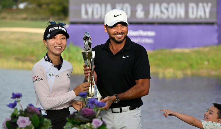 Lydia Ko, left, and Jason Day, right, hold the championship trophy after winning the Grant Thornton Invitational, the first mixed-team golf tournament since 1999, Sunday, Dec. 10, 2023, in Naples, Fla. (AP Photo/Steve Nesius)