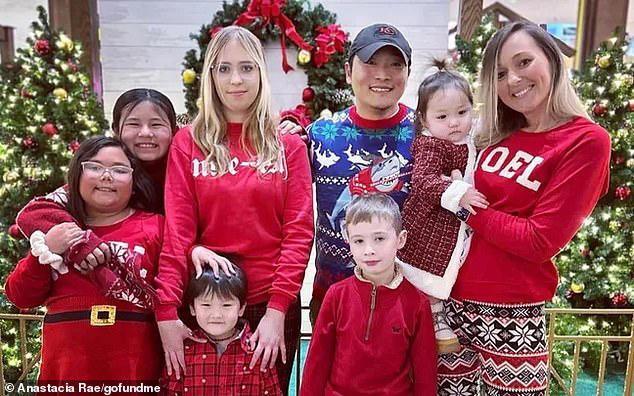 Michael Snyder, a 42-year-old father-of-six, died while rocking his baby daughter Lily - seen here at right with mom Alicia - to sleep in Kansas on December 2. His death was sudden, and has left the family - seen celebrating Christmas last year - reeling before the holidays