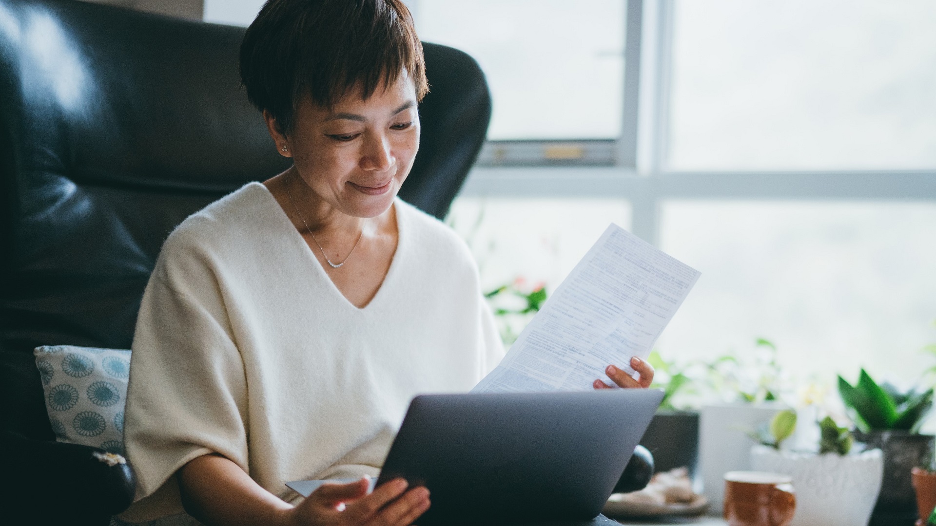 woman looks at paperwork retirement taxes_iStock-1307083269