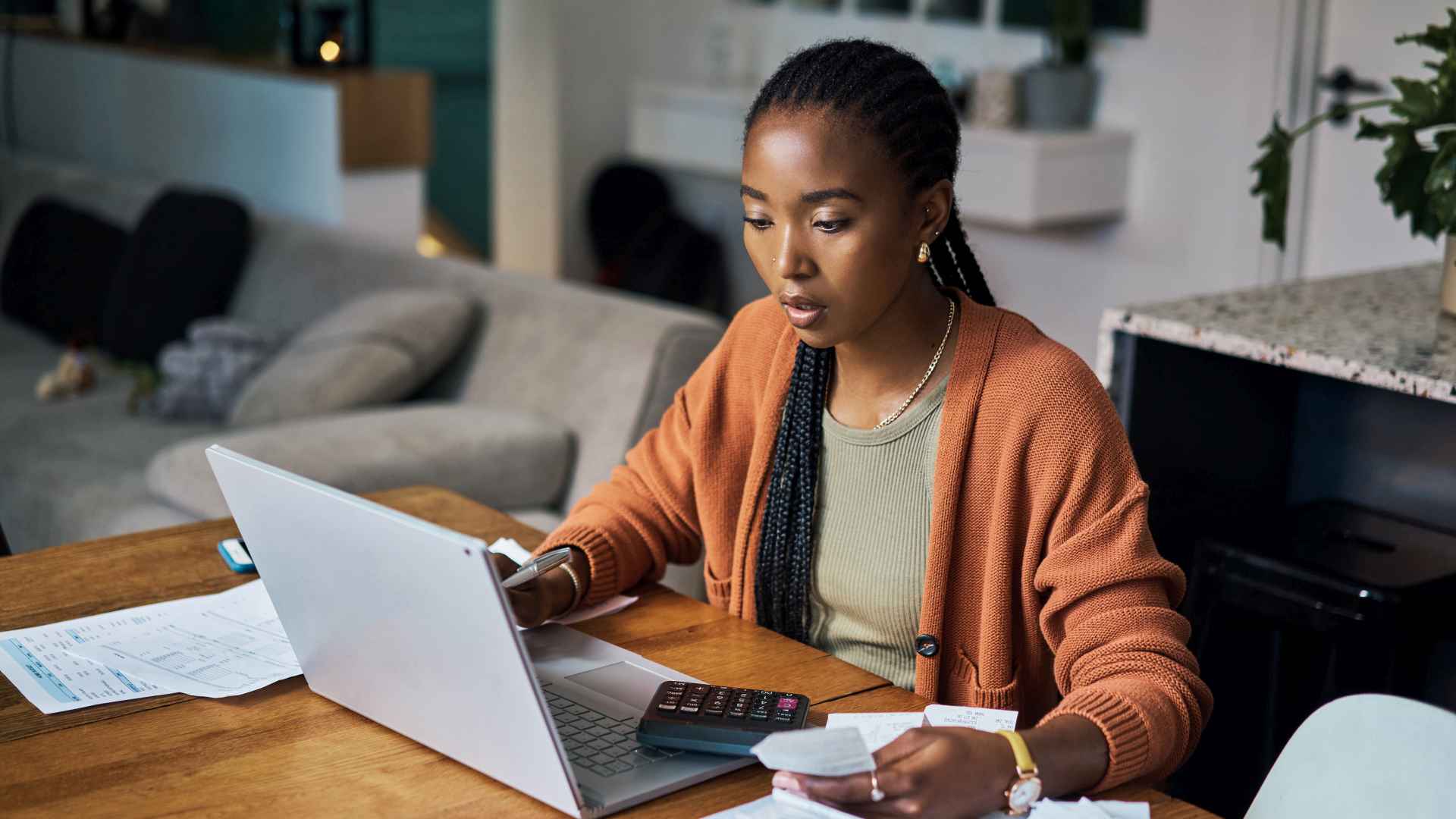 Black woman, budget and home finance on laptop for accounting, money planning and fintech investment. Paper bills, savings and web payment review, online banking and insurance loan of financial taxes