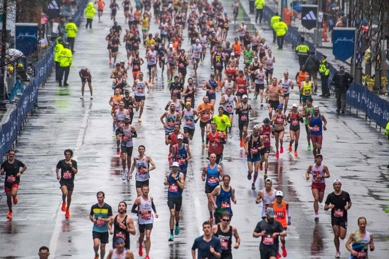 Thousands of runners make their way to the finish line during the 127th Boston Marathon.