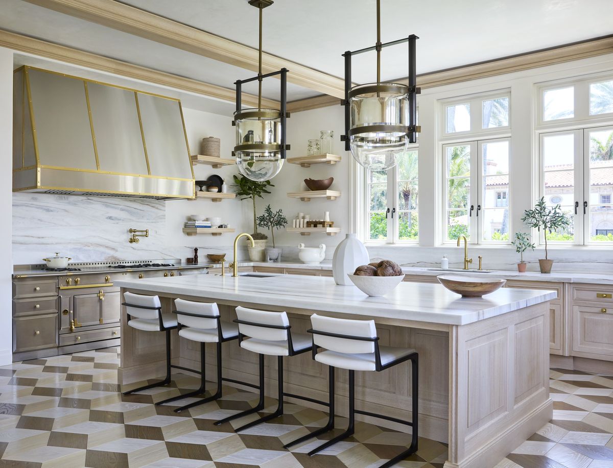 The backsplash and countertop’s wispy veining (Calacatta lasa gold marble) and custom cube flooring design bring movement to the kitchen. Stools, <a href="https://www.hollyhunt.com/" target="_blank">Holly Hunt</a>