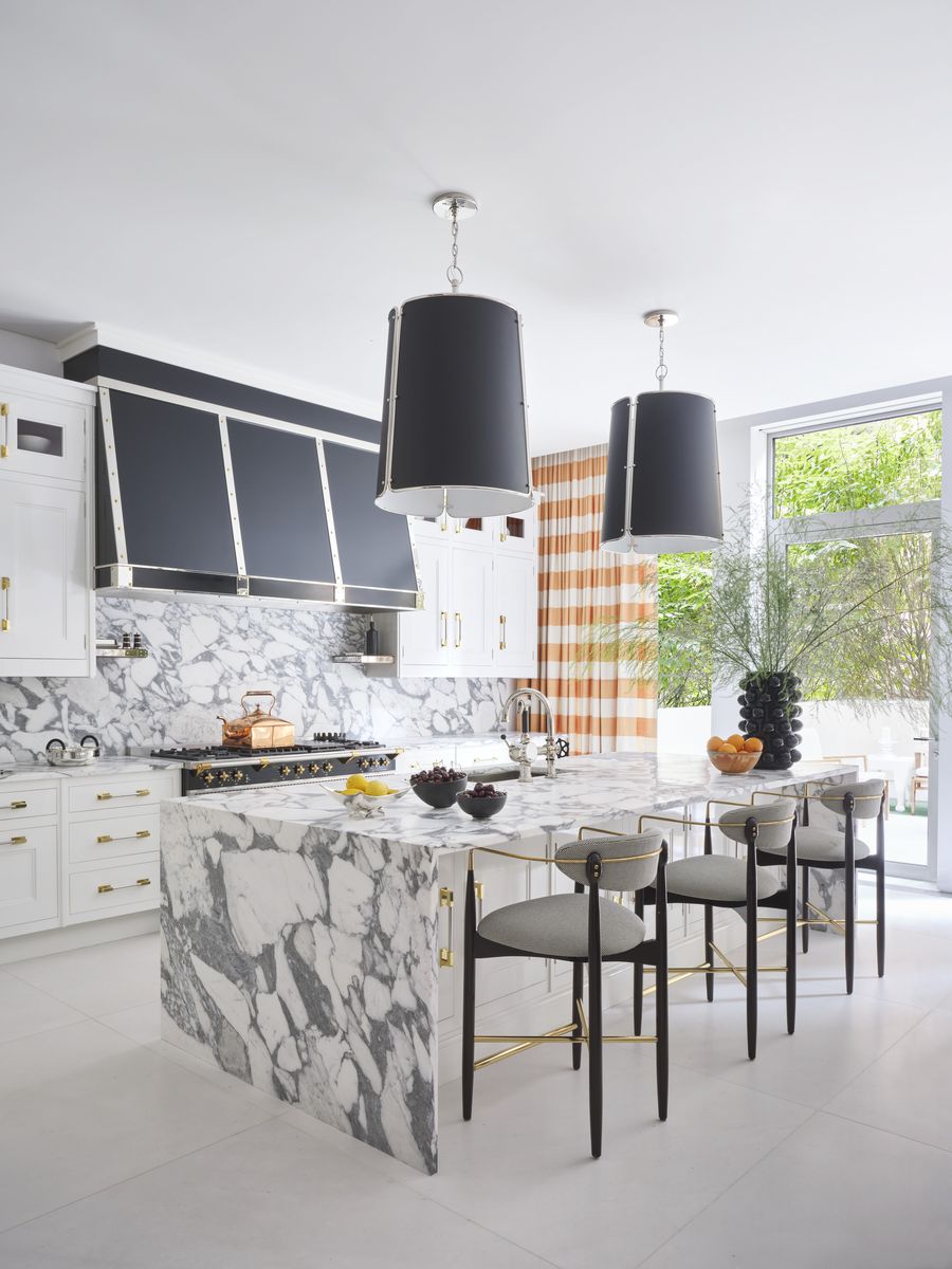 <p>The stone-clad kitchen (<a href="https://peacockhome.com/">Christopher Peacock</a>) features a mix of dolomite, arabescato, and sivec surfaces. Pendants, Carrier and Company for <a href="https://go.redirectingat.com?id=74968X1553576&url=https%3A%2F%2Fwww.visualcomfort.com%2F&sref=https%3A%2F%2F">Visual Comfort & Co. </a></p>