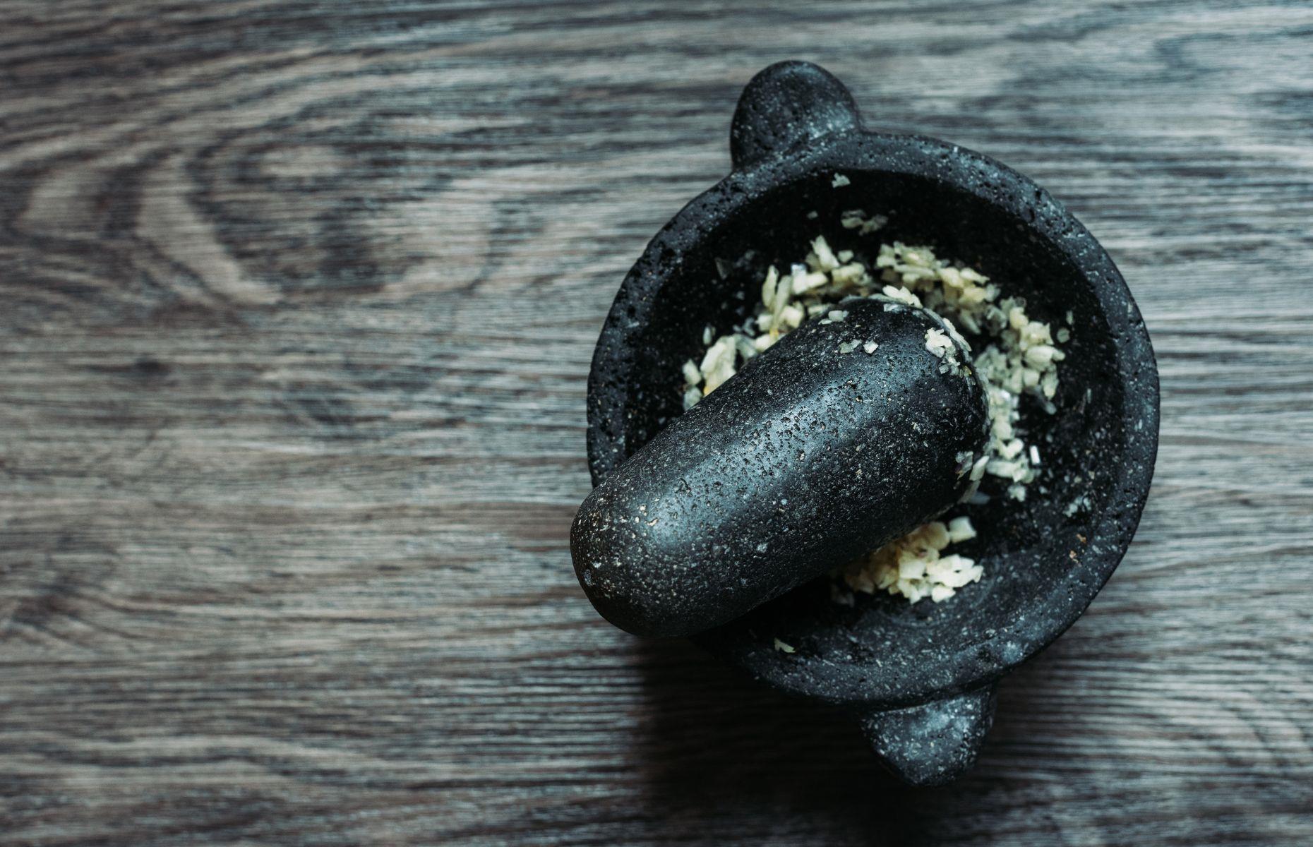 <p>Rather than using a garlic press, which can be a bit of a pain to wash up, Nigella crushes garlic in a pestle and mortar. She also adds a pinch of her favorite Maldon Salt to help the process along.</p>