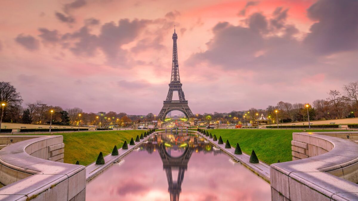 Eiffel Tower with pink skies and reflection in the water 