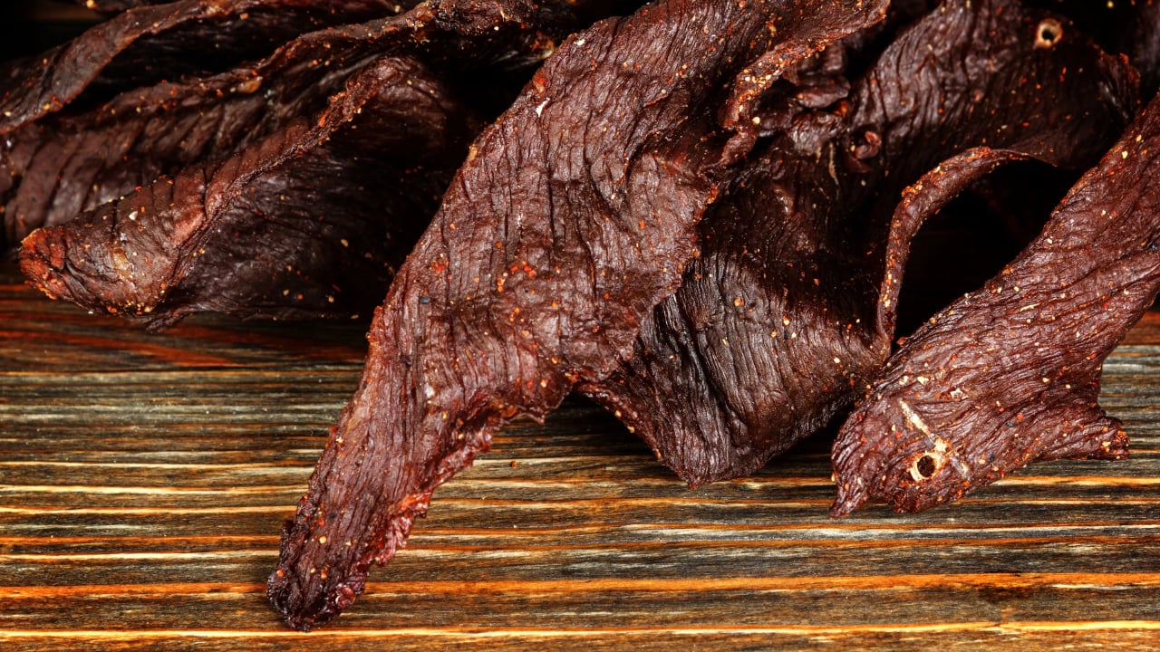 <p>Beef jerky makes a popular road trip food because it’s so portable — what’s easier than eating a stick of meat right out of the wrapper? In <a href="https://www.southernliving.com/best-buc-ees-jerky-flavors-7371168" rel="nofollow noopener">a Southern Living interview</a> this year, Josh Smith, director of operations for Buc-ee’s Southeast division, said the chain’s beef jerky has been one of its most popular items since opening. It makes sense, then, that some stores have entire walls dedicated to the snack food. Wondering what the most delicious Buc-ee’s food option is? With flavors like Korean Barbecue, Bohemian Garlic, Ghost Pepper, and more, there’s an option for everyone.</p>