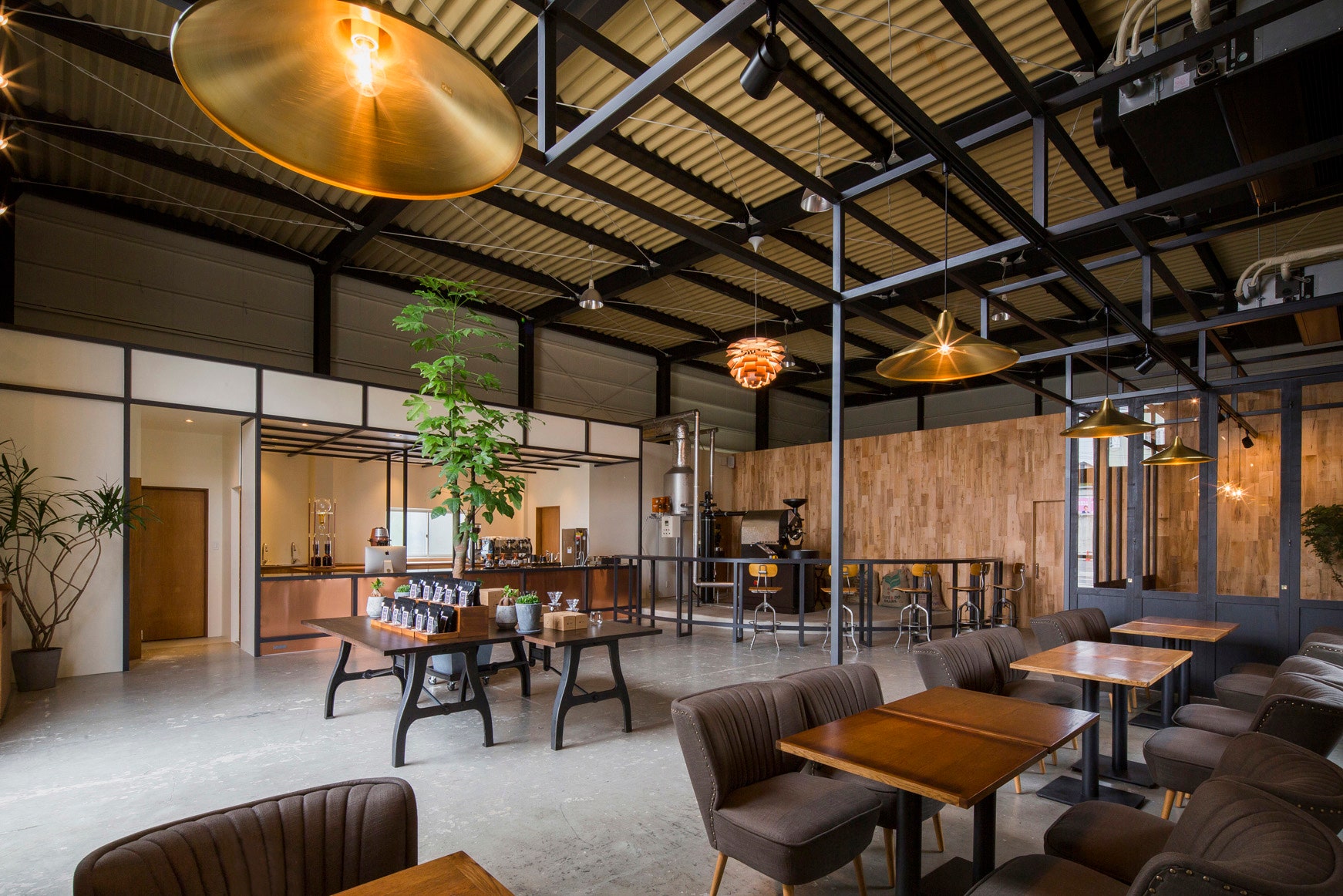 Architecture firm Iks Design transformed a warehouse into a warm and tranquil coffee shop in Japan. The firm outfitted the space using brass and copper accents, including the copper-clad coffee bar. The roaster is set on a platform and surrounded by bar seating, allowing patrons to watch the roasting process.<p>Sign up for our newsletter to get the latest in design, decorating, celebrity style, shopping, and more.</p><a href="https://www.architecturaldigest.com/newsletter/subscribe?sourceCode=msnsend">Sign Up Now</a>