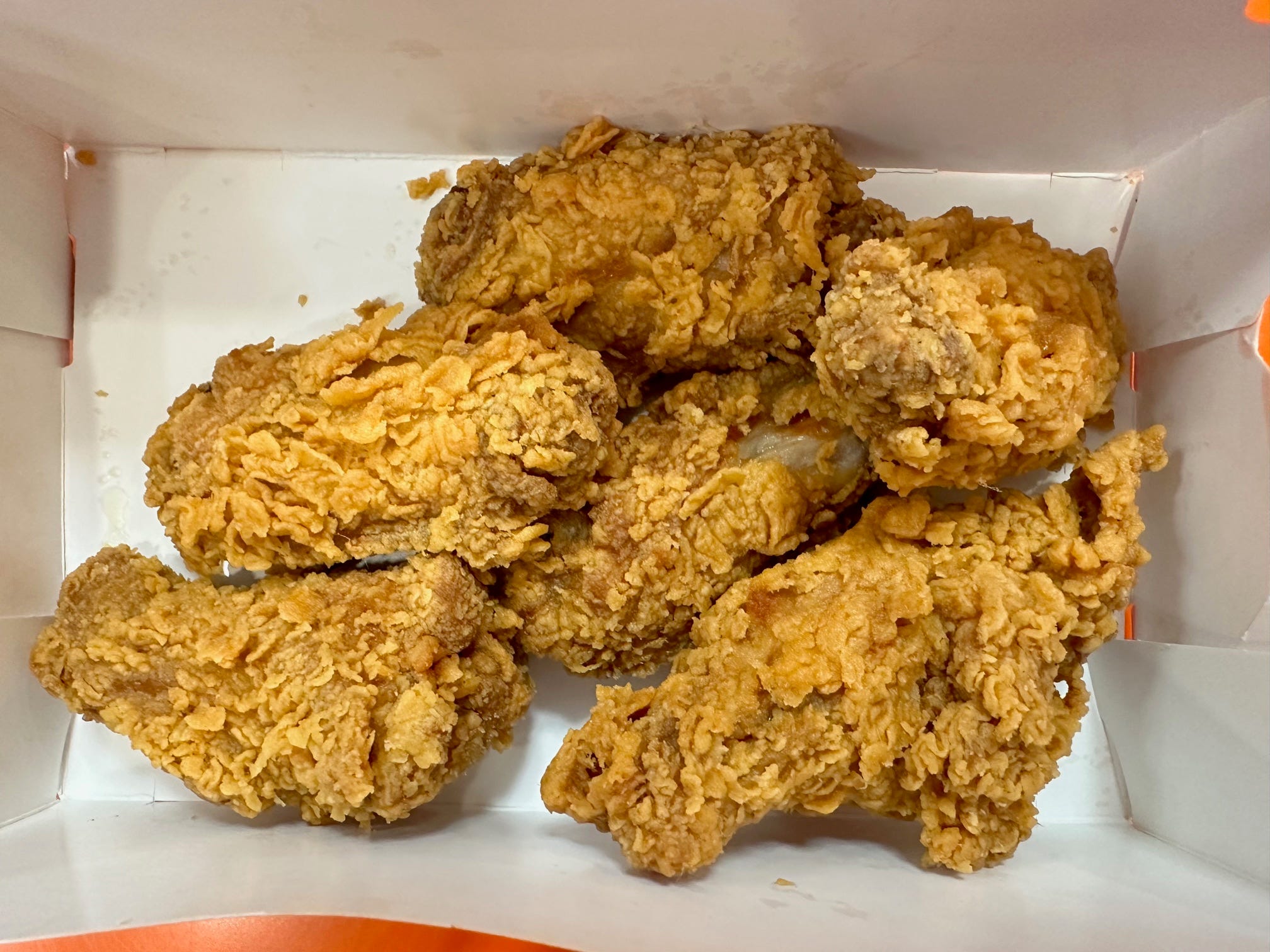 <p>Unlike the other wings, the Ghost Pepper wings are not slathered in any spicy sauce.</p><p>Instead, the flavor on this wing is in the actual chicken. The manager told me it was marinated for 12 hours in ghost pepper spices.</p><p>That explains why it didn't look intimidating. I was expecting a wing with hues of deep red or orange breading, indicators of spices blended into the outer coating. But the ghost pepper spices are not in the breading.</p><p>I was not intimidated by these wings at all. They were very approachable. But that's what made them a letdown. I couldn't taste any heat.</p><p>I would suggest eating these over the Roasted Garlic Parmesan wings if you're nervous about getting too much heat.</p>