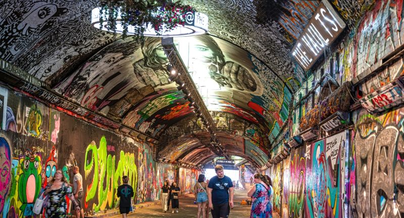 <p>Located beneath the railway tracks of Waterloo Station in London, the Leake Street Arches constitute a unique tunnel adorned with vibrant street art. Since the famous “Banksy Tunnel” initiative in 2008, the space has become a legal street art gallery, showcasing an ever-changing display of urban art.</p>