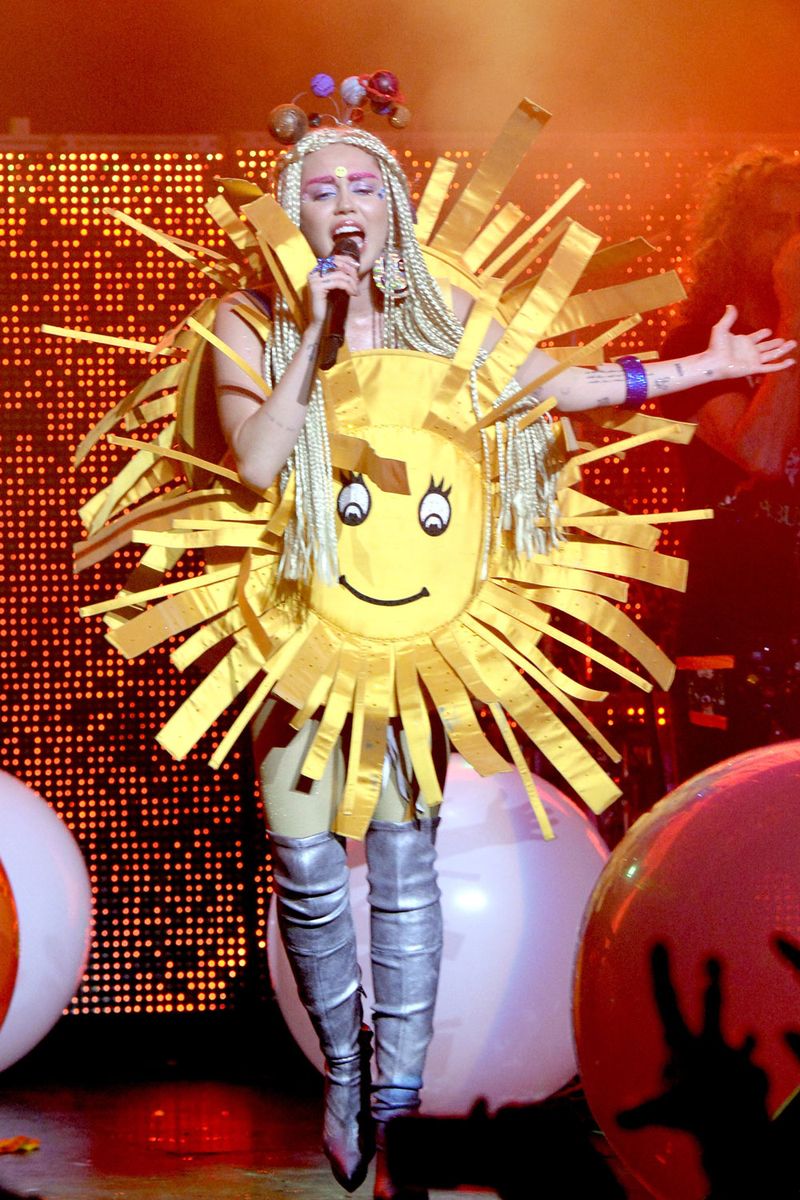 <p>Doubt this is what The Beatles had in mind when they were singing “Here Comes the Sun,” but anyway, here’s Miley dressed as one. And she also has lil baby planets on her head to complete the solar system. </p>