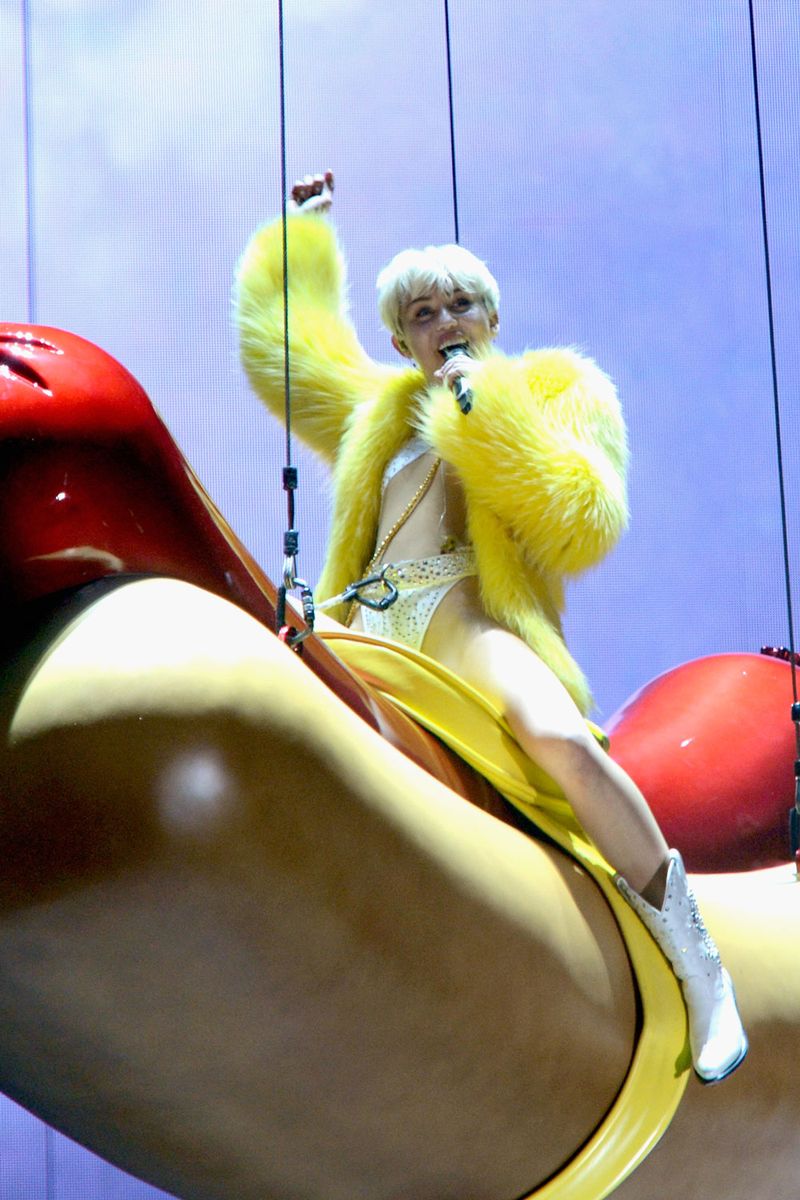 <p>To promote her fourth studio album, <em>Bangerz</em>, Miley swung into her concert like a wrecking ball hot dog in this Big Bird–esque feathered coat. </p>