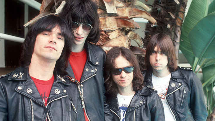 <p>New York punk rockers The Ramones helped bring the genre into the mainstream with its short and concise hits. Although they aren’t related, each member of the band took on the fictional ‘Ramone’ surname to make it seem like they were brothers. Dressing in ripped drainpipe jeans, white tees, and leather jackets, the Ramones were the defining look of the punk movement. Their hits were based upon simple chords and punchy lyrics, with songs like ‘Blitzkrieg Bop’ and ‘I Wanna Be Sedated’ being the Ramones’ best-known songs.</p>
