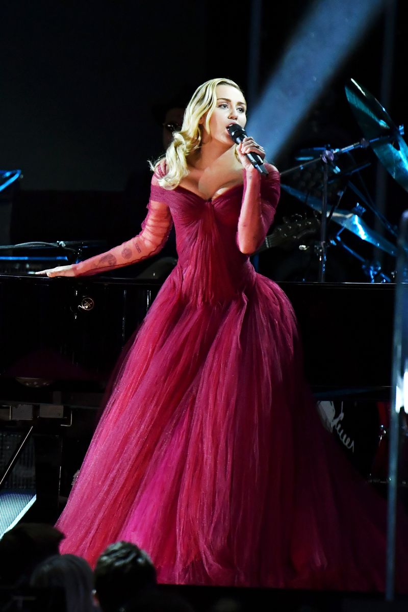 <p>Miley looked absolutely breathtaking in a deep-red Zac Posen gown at the Grammy Awards. Here, she performed “Tiny Dancer” with Elton John for a throwback duet. </p>
