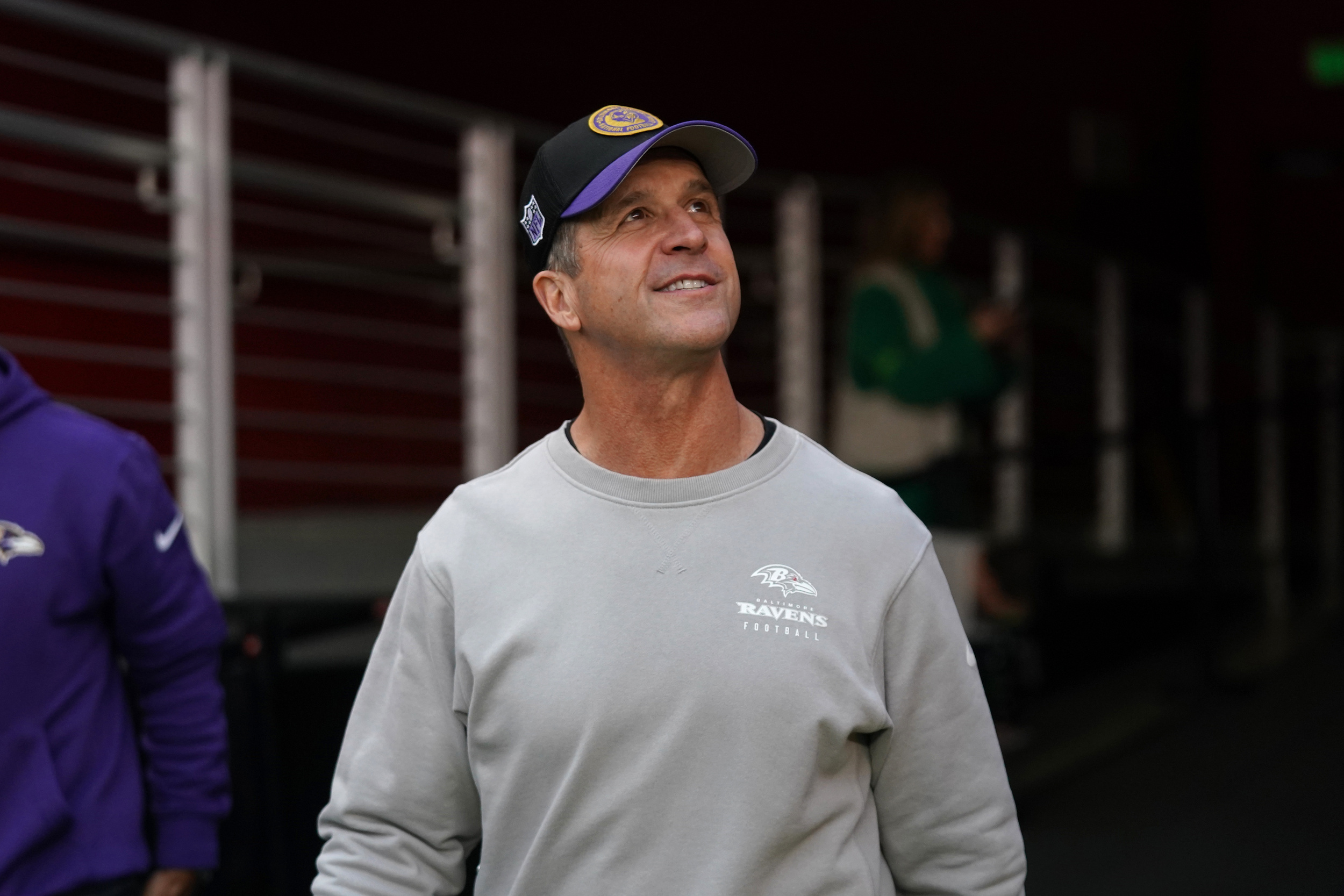 Watch: Ravens HC John Harbaugh Surprises Brother, Jim, At CFP Title Game