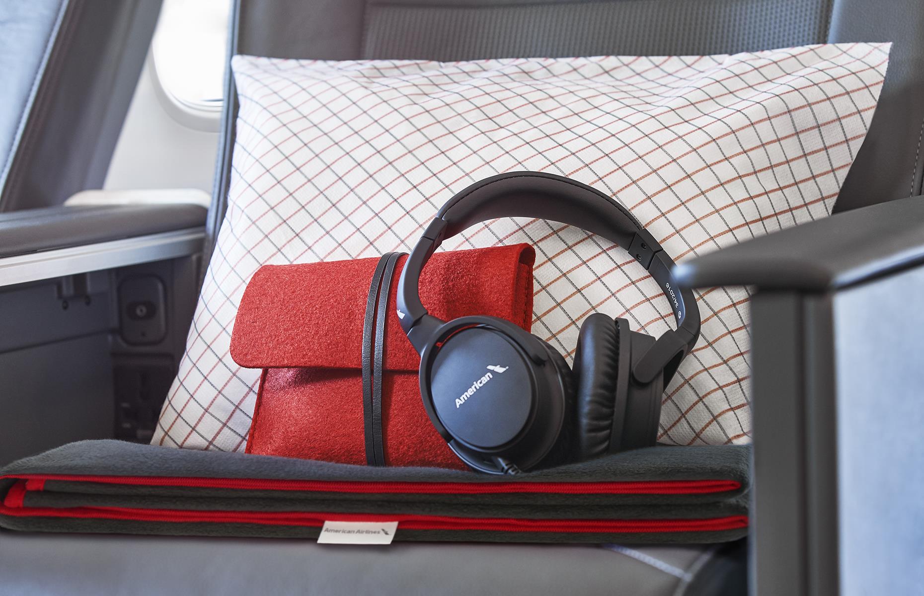 Firstly, why would you want to steal economy headphones? Secondly, in premium economy and above, you aren’t allowed to take them with you, sadly.   For instance, Bang & Olufsen headphones are handed out in American Airlines business class – the flight attendants keep track and know exactly who’s used a pair, so you won't get away with it even if you did try to nab them.