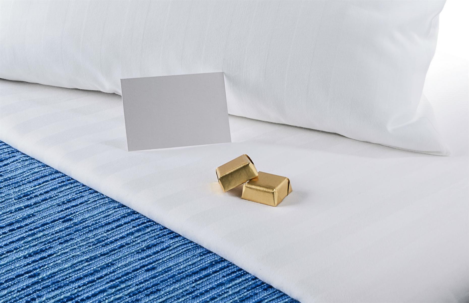 <p>This is pretty much the only thing on your bed that you are allowed to consume or take home. The same applies to the complimentary cookies by the tea and coffee making facilities, if there are any.</p>