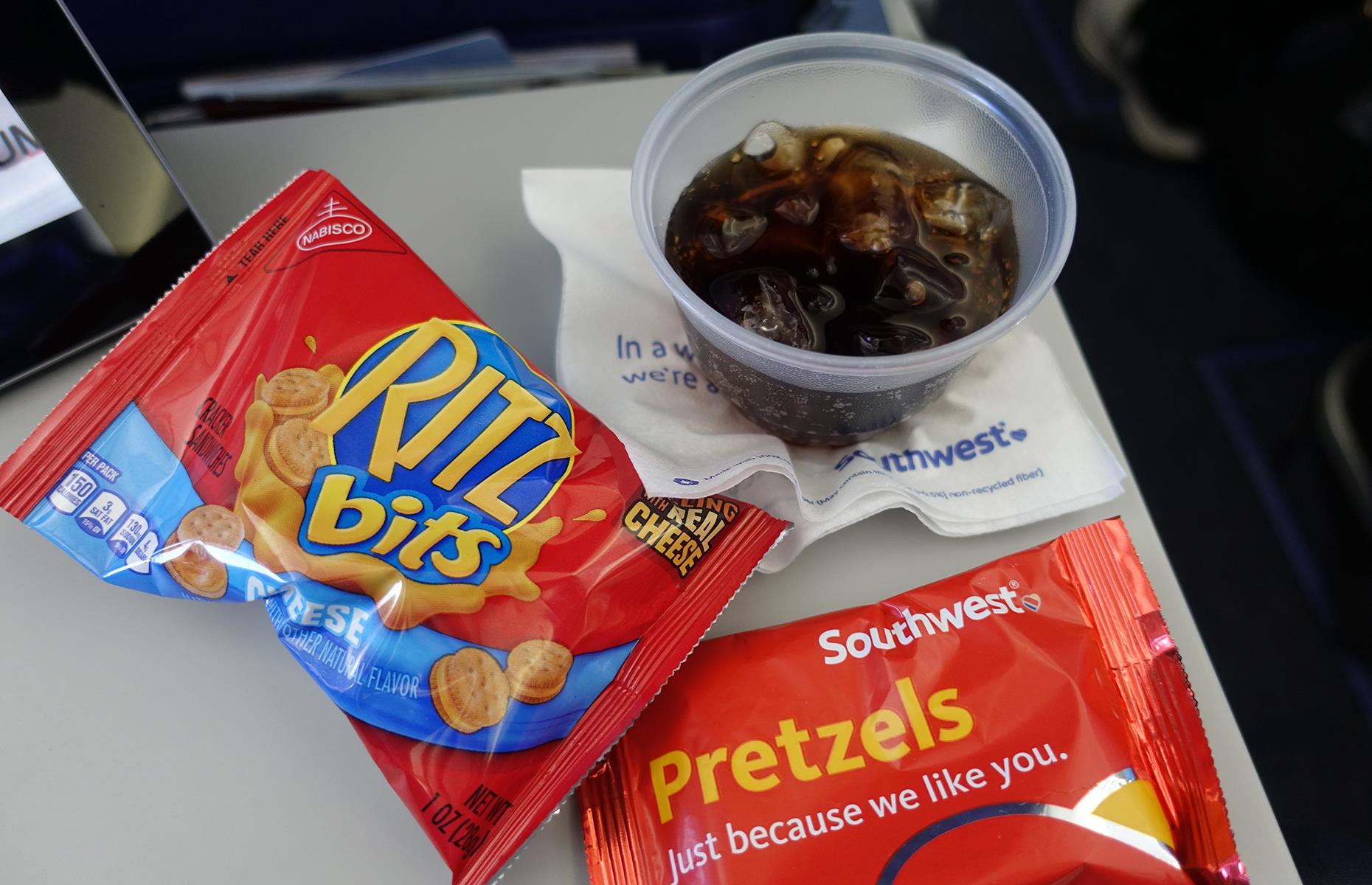 <p>Unlike the minibar in hotels, the snack box on a plane is a glorious free-for-all. Maybe don’t tip the entire thing into your bag, but definitely hoard some of the chips and candy bars for later.</p>
