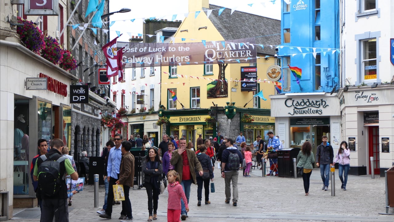 <p><a href="https://www.galwaytourism.ie/connemara/the-twelve-bens/" rel="noopener">Galway’s</a> past as a thriving seaport gave it a colorful history reflected in its lively Latin Quarter with its collection of more than 50 restaurants, various shops, and several pubs, many still heated by traditional turf fires. Nearly the entire waterfront is parkland, with plenty of opportunities to enjoy the waterfront. From Rossaveel (about 45 minutes to the west), you can also visit the Aran Islands, where you can visit ancient ruins, see filming locations from <em>The Banshees of Inisherin</em>, shop for locally made wool products, or take in the natural beauty.</p>