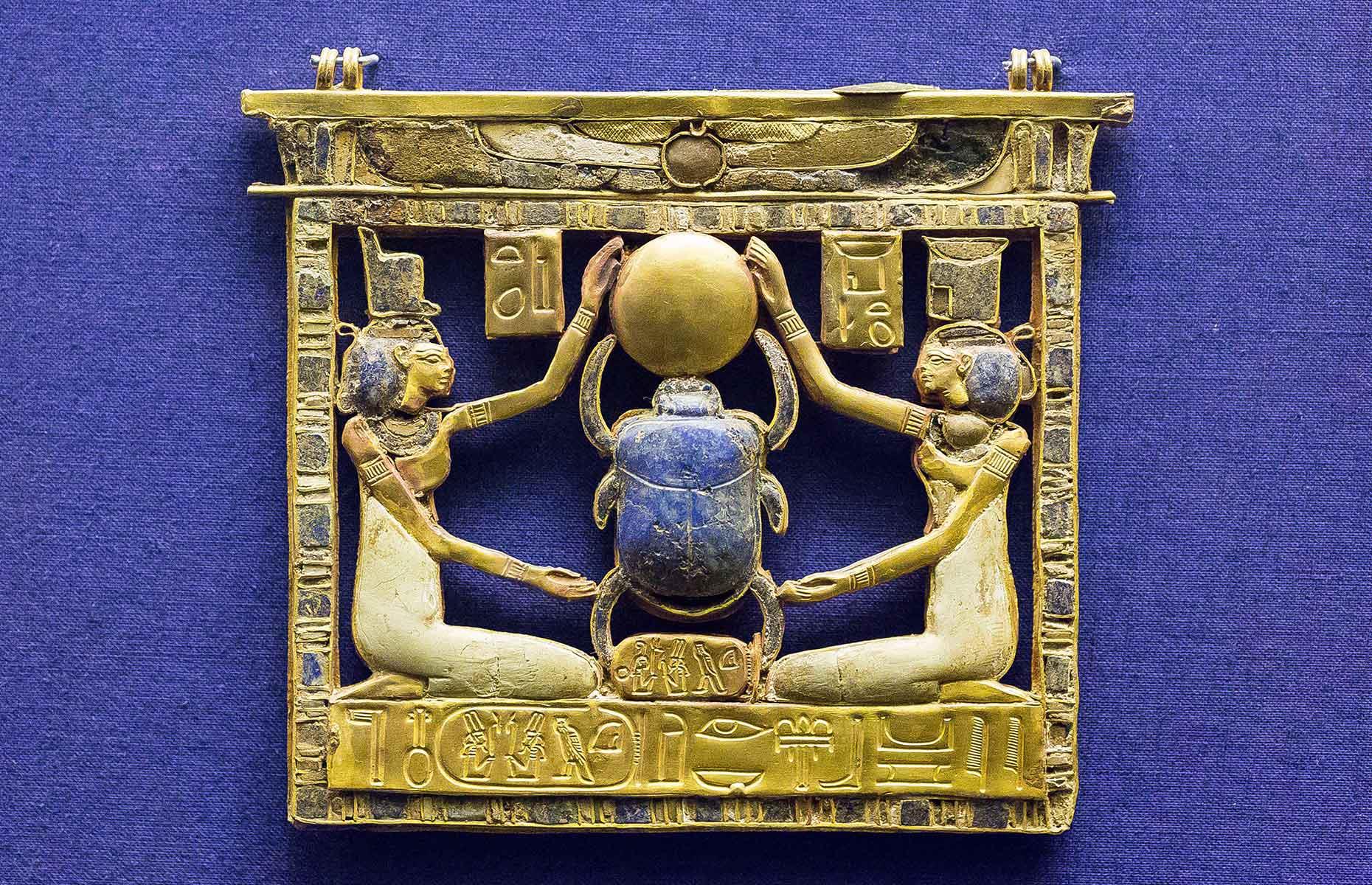 <p>Discovered inside the tomb of king Amenemope (a 21st-dynasty pharaoh) was this detailed pectoral brooch. At the centre is a lapis lazuli scarab touching the golden sun disc, representing rebirth. The scarab is flanked by the goddesses Isis and Nephthys, who protected the wearer, while along the bottom runs a cartouche, an inscription of the king's name. </p>  <p><a href="https://www.loveexploring.com/gallerylist/70876/littleknown-incredible-roman-ruins-around-the-world"><strong>Discover these little-known Roman ruins from around the world</strong></a></p>