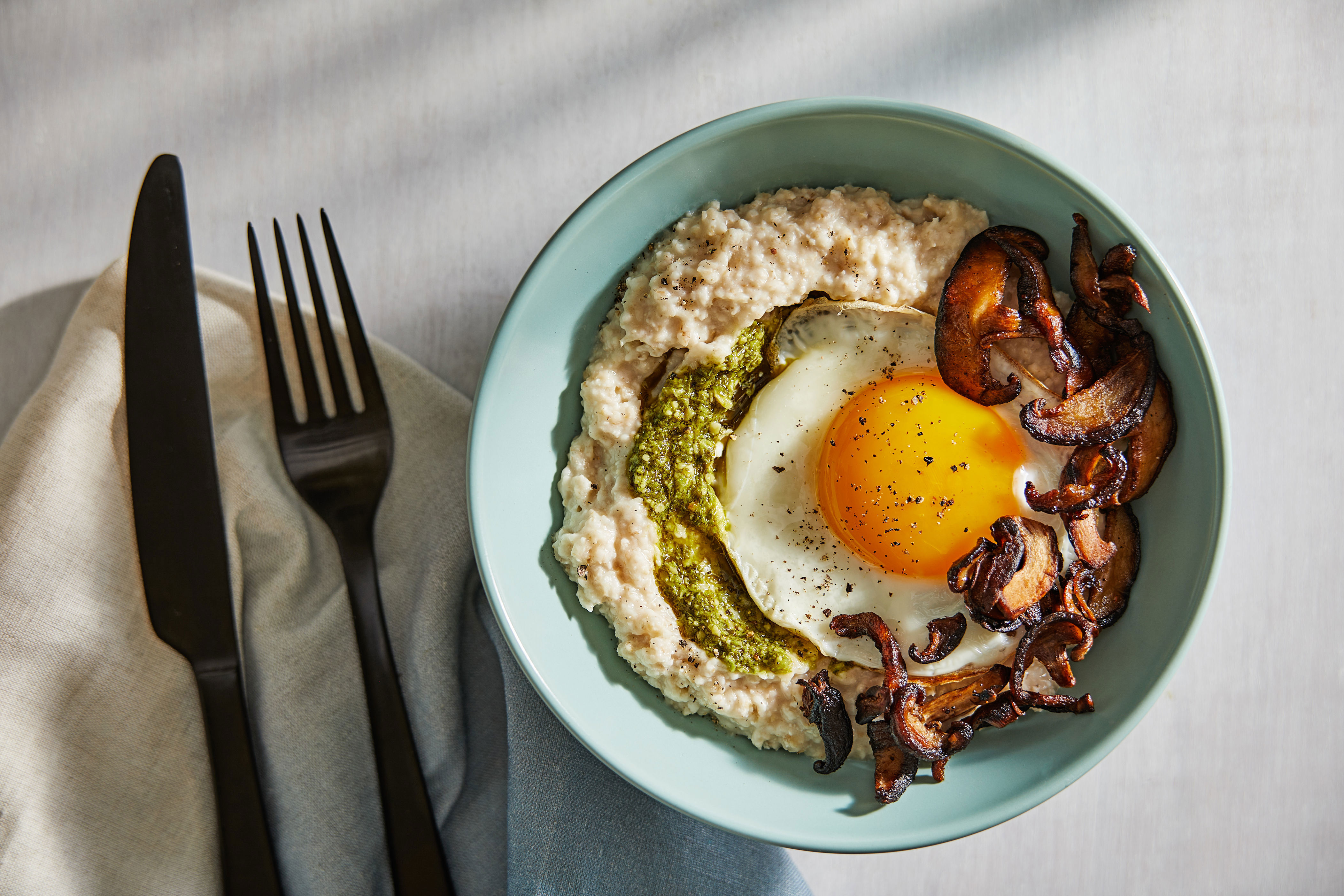 Shake up breakfast with savory oatmeal with eggs and pesto